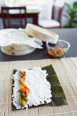 plant-based food, homemade vegan sushi with stir fried vegetable filling getting prepared