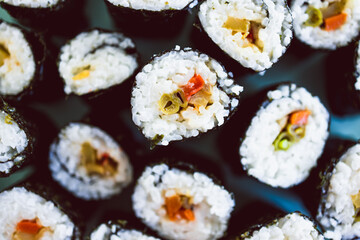 plant-based food, homemade vegan sushi with stir fried vegetable filling