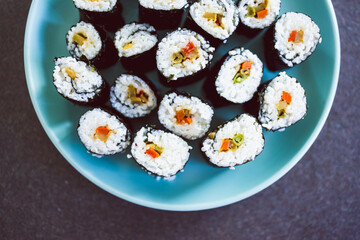 plant-based food, homemade vegan sushi with stir fried vegetable filling