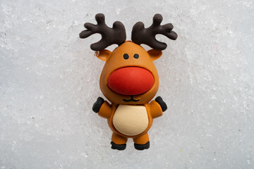 christmas decorative doll of a very cute reindeer on snow