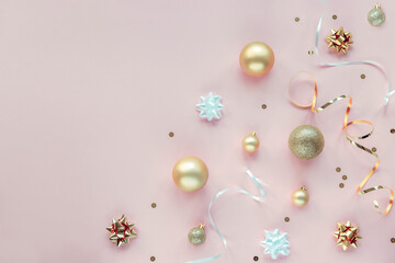 Pink New Year background with Christmas balls, baubles and confetti. Top view, flat lay, copy space