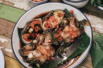 Korean food traditional fresh crab raw soy sauce marinated or Ganjang gejang in Korean name served in white plate on wooden table.