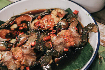 Korean food traditional fresh crab raw soy sauce marinated or Ganjang gejang in Korean name served in white plate on wooden table.