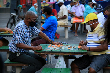 salvador, bahia, brazil december 2, 2020: people playing checkers in a public square in the city of...