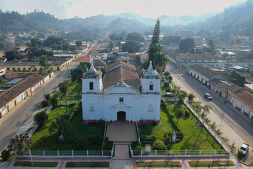 Aerial photo of an antique cathedral that is illuminated by a nice sunrise light