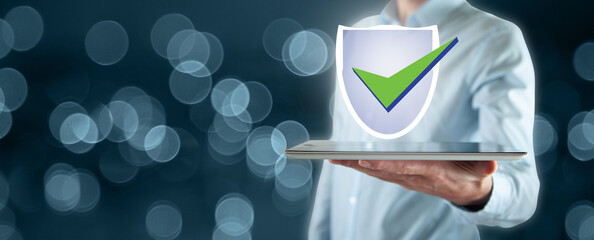 Hand holding tablet with glowing antivirus interface