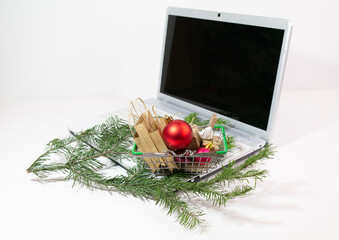 Online Christmas Shopping Cart and fir branch on light background, christmas online shopping, selective focus