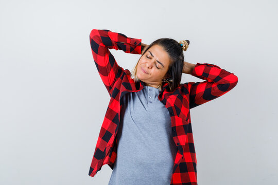  Beautiful Lady Holding Hands Behind Head While Stretching In Casual Clothes And Looking Relaxed. Front View.