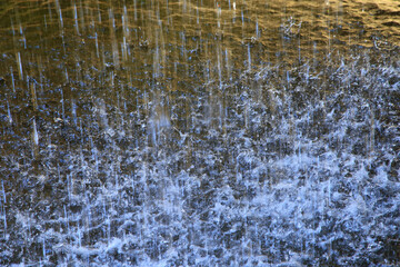 splashing water at natural waterfall