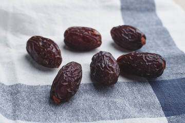 fruit date palm on a white tablecloth and craft paper. symbol of abundance in Ramadan. sweet...