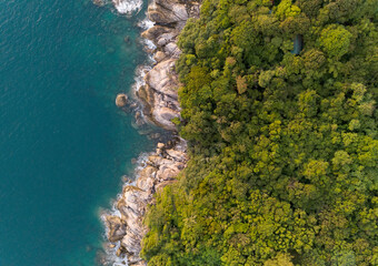 High angle view Tropical sea with wave crashing on seashore and high mountain located in Phuket Thailand aerial view drone top down Amazing nature view