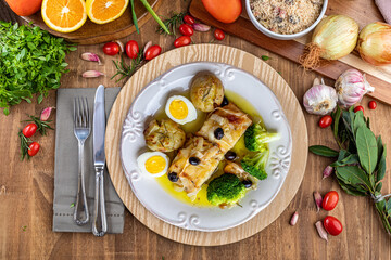Cod loin baked in olive oil, with potatoes, broccoli, boiled egg and black olives. Typical dish of...