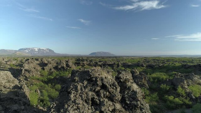 Descending through lava rock formations and trees Dimmu Borgir Iceland aerial