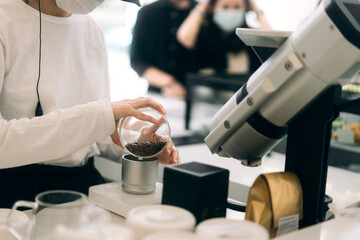 Fototapeta na wymiar Woman hand staff make a coffee drink working in cafe.