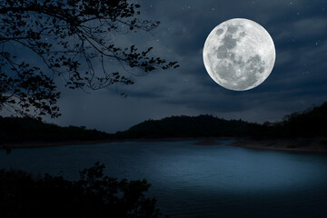 Full moon on the sky over lake at night.