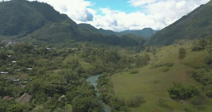 Drone aerial rising shot, landscape view of the tropical valley, mountains and river Cahabon in Guatemala