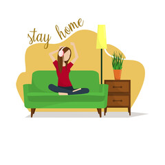 The girl sits at home on the sofa with headphones listening to music. Quarantine, stay at home picture. covid-19.