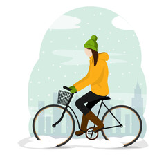 The girl walks on a bicycle in the winter city. It's snowing outside.