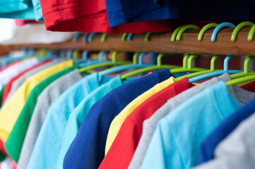 Colorful of T Shirts are hanging on the clothes hanger