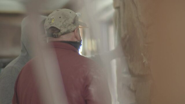 Construction manager is pointing at the stone giving direction