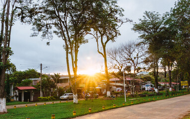 Sunset sun rays coming through trees in a small town in Colombia