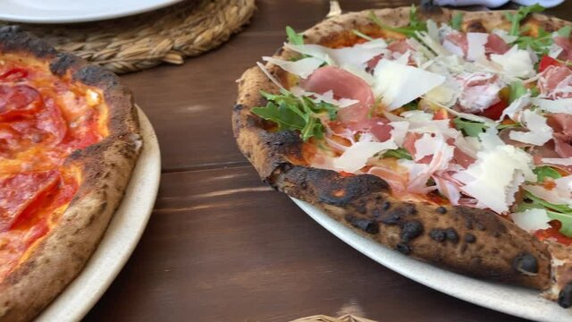 Neapolitan stone oven-baked pizzas 4k dynamic moving shot in an Italian restaurant