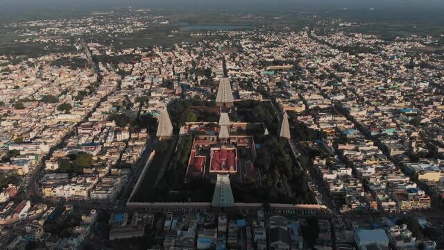 Aerial flyover famous giant Tiruvannamalai Temple Complex during sunny day in India.Tilt down camera movement.