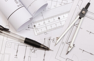 Rolled electrical diagrams and accessories for drawing. Engineer jobs concept