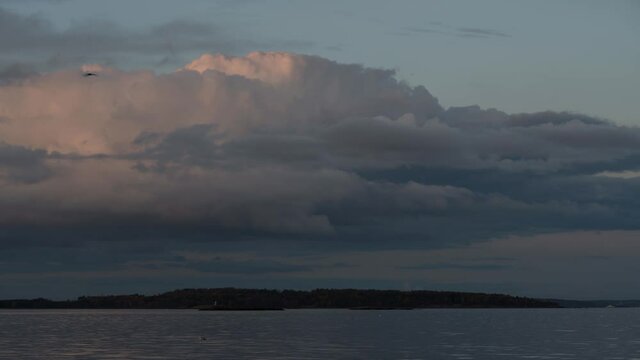 Beautiful coloured clouds by sunset. Oslofjord in Norway, time lapse footage