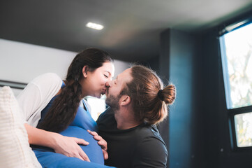 Obraz premium Happy pregnant couple waiting for baby at home, Pregnant couple of husband and wife
