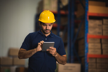 Man warehouse worker with a tablet