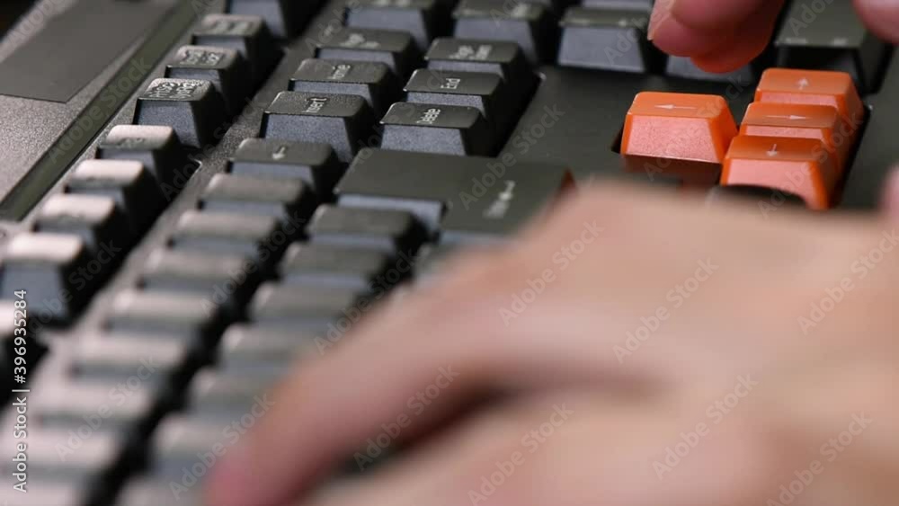 Poster extreme close-up on the gaming computer keyboard while playing a computer game.focus on the right ha