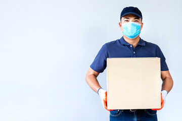 Asian delivery man employee in blue cap blank t-shirt uniform face mask gloves hold empty cardboard box isolated on white background , Concept of prevention of the spread of coronavirus