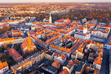 View from drone of Kalisz cityscape at sundown overlooking steeples of Cathedral of St. Nicholas Bishop, Collegiate Basilica and Town Hall, Poland
