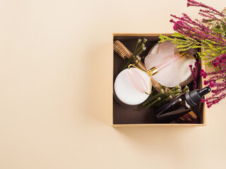 Zero waste beauty skin care gift box with flowers. Guasha, essential oil, bamboo toothbrushes