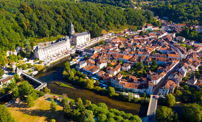 Scenic drone view of Brantome en Perigord on Dronne river with former Benedictine abbey on sunny summer day, Dordogne, France..