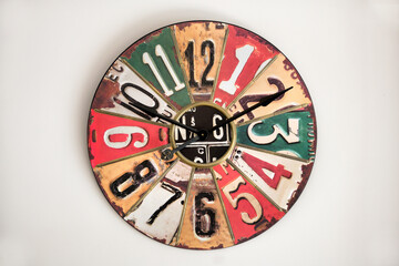 Clock with vintage metal face on white wall