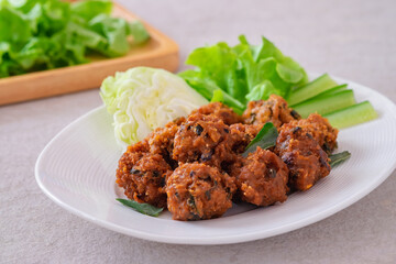 Deep fried spicy minced pork served with vegetable on  plate, Thai food