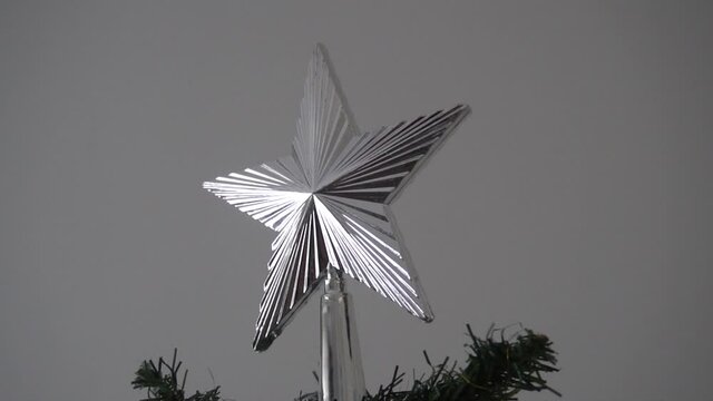 Christmas tree with star on top of the tree. A tradition to put this symbol on a very decorated tree, to attract happines and joy during the last days of the year and close to Jesus date of birth