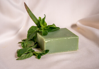 Refreshing green color soap made of mint with white background.