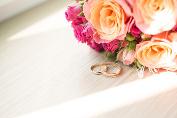 wedding rings and a bouquet of roses