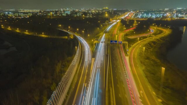 Aerial hyperlapse of a highway in the Netherlands road traffic passing timelapse commuting everning night dark top down fly over