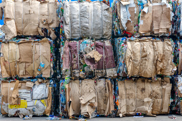 Pressed paper and cardboard bales. Garbage disposal plant - obrazy, fototapety, plakaty