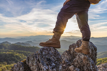 Hiker standing on top mountain sunset background. Hiker men's hiking living healthy active...