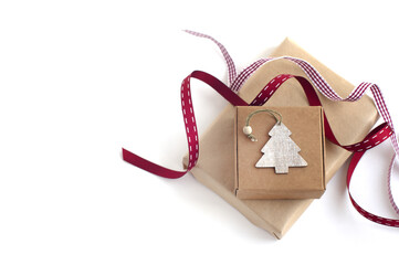 gift boxes, red ribbons, small wooden Christmas tree on a white background. gift preparation.