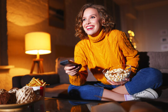 Happy Woman With Popcorn Watching TV At Night.