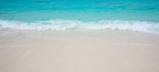 Beach with white sand and soft blue ocean wave