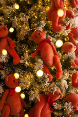 Fototapeta na wymiar Toy bears. Decorating a Christmas tree. Festive mood, bokeh