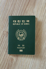Republic of Korea passport on wooden texture
