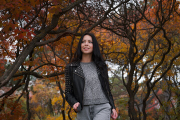 Autumn woman in the autumn park. Warm weather.